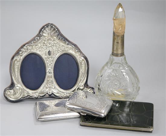 Two silver cigarette cases, a silver mounted photograph frame, a silver mounted scent bottle and similar wallet.